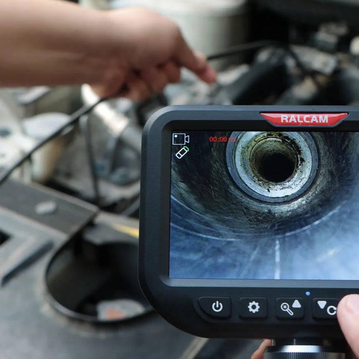 Borescope probe inserted through spark plug hole for engine cylinder inspection